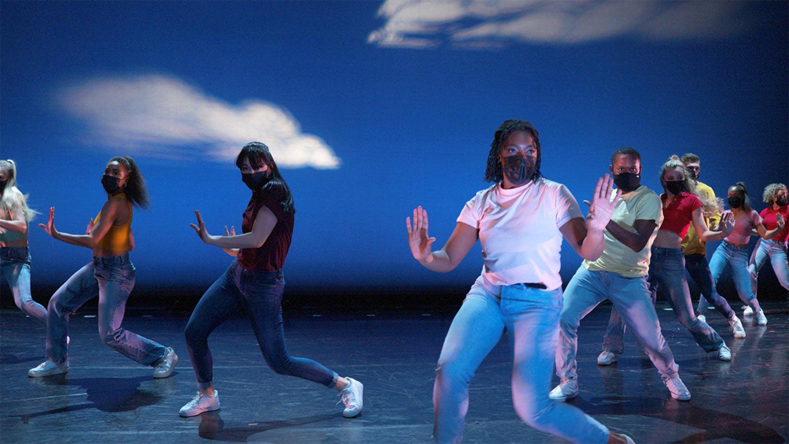 Sands College of Performing Arts students dancing on stage in masks