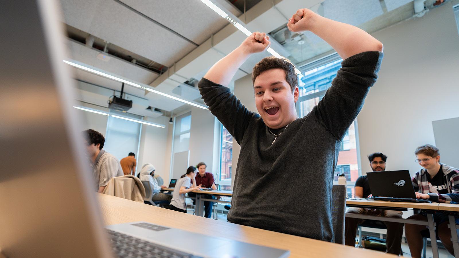 A Pace student cheers as he completes a video game