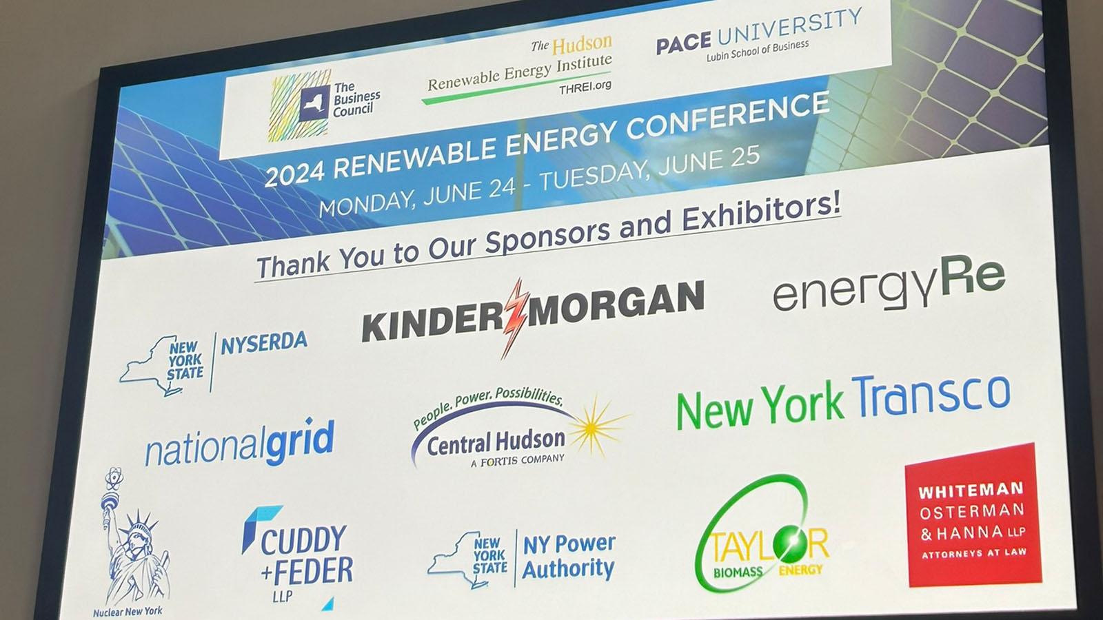  2024 Renewable Energy Conference sign listing sponsors and exhibitors: Kinder Morgan, NYSERDA, energyRe, National Grid, Central Hudson Gas & Electric Corp., New York Transco, Taylor Biomass Energy, Whiteman, Osterman & Hanna LLP, Nuclear New York, Cuddy & Feder LLP, and the New York Power Authority.
