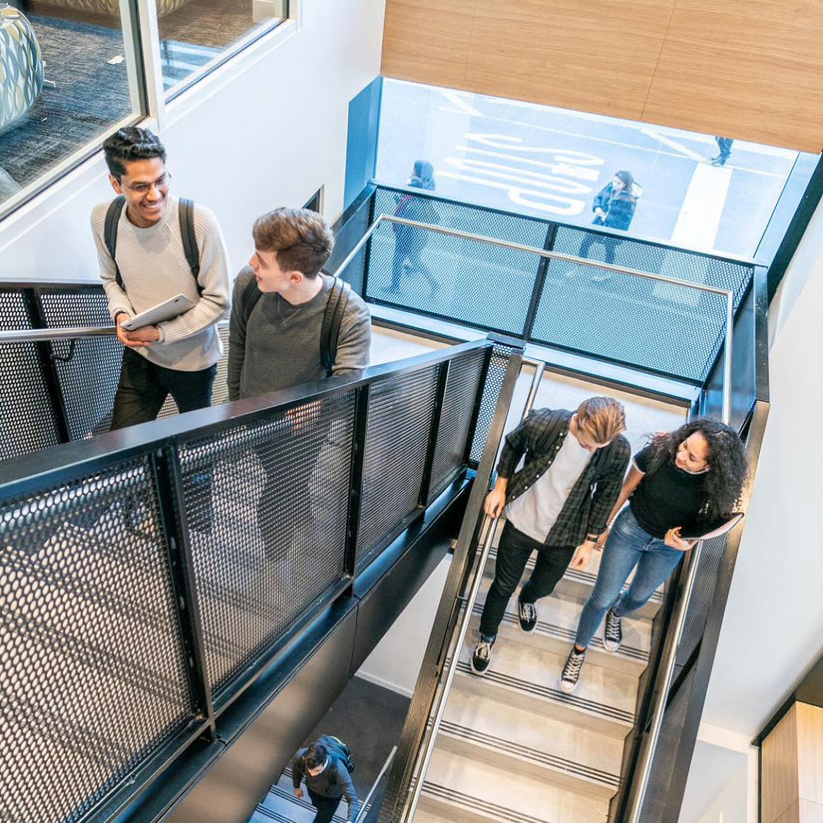 Students walking down a staircase.