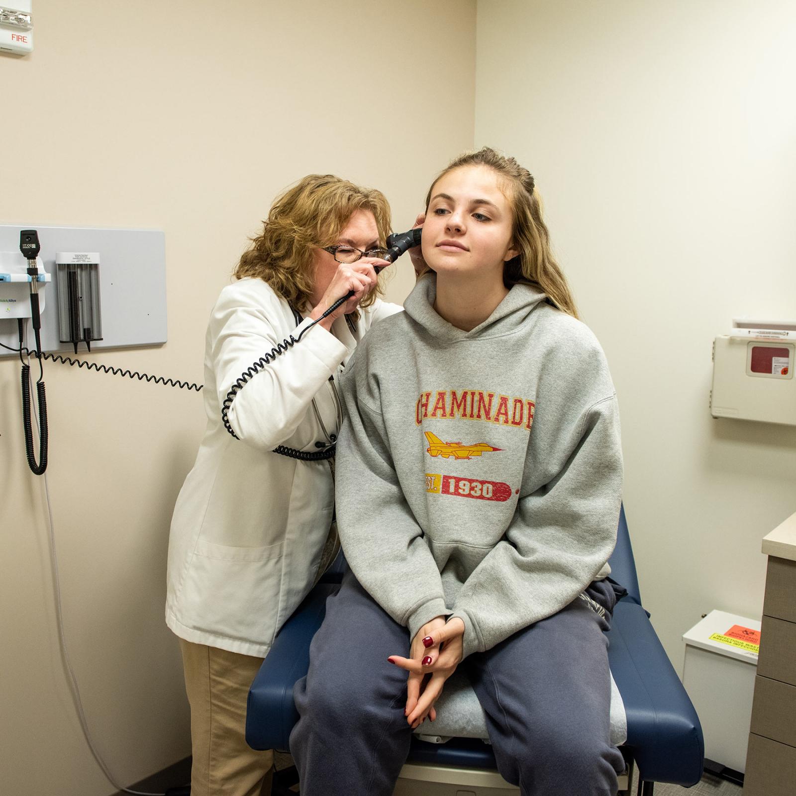 Student being checked by a nurse at the University Health Care center.