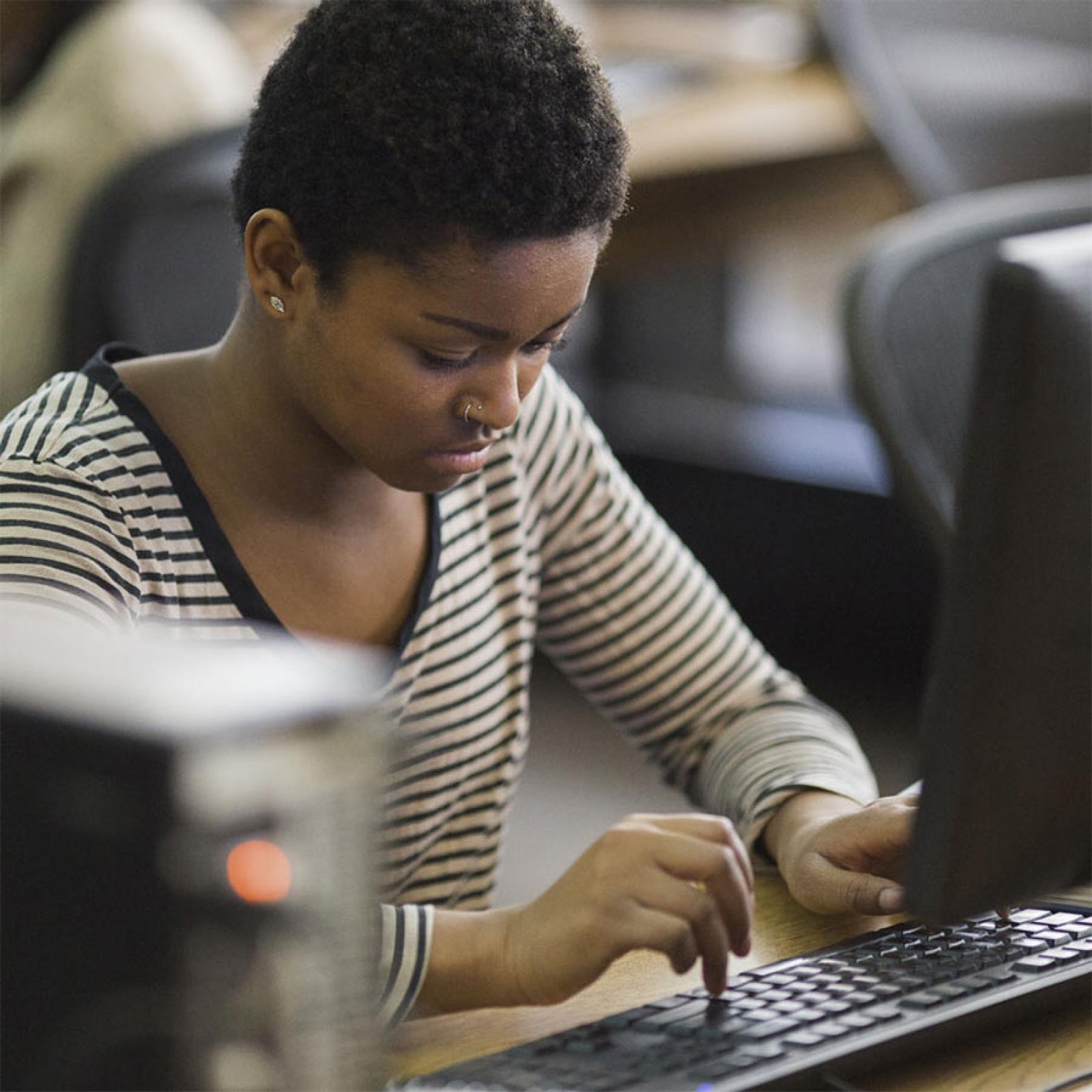 young woman typing on a computer