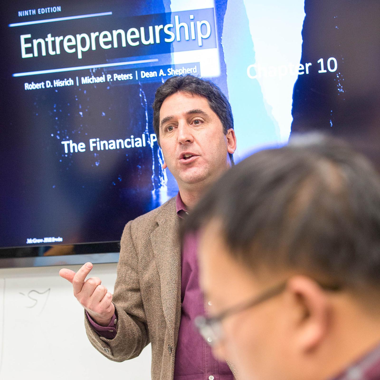 Lubin management professor teaching a group of students in a classroom in One Pace Plaza, New York City Campus