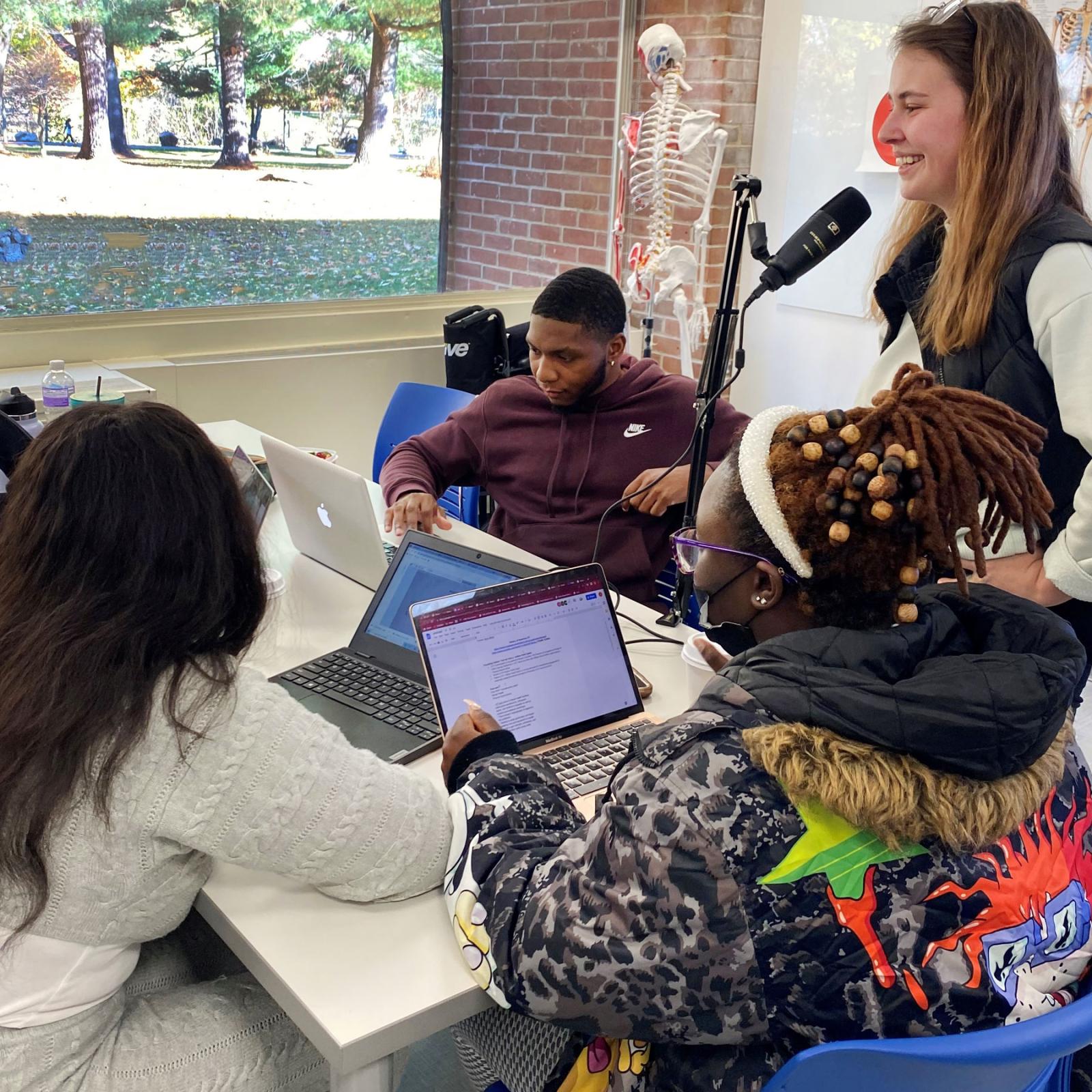 group of people with a podcasting microphone