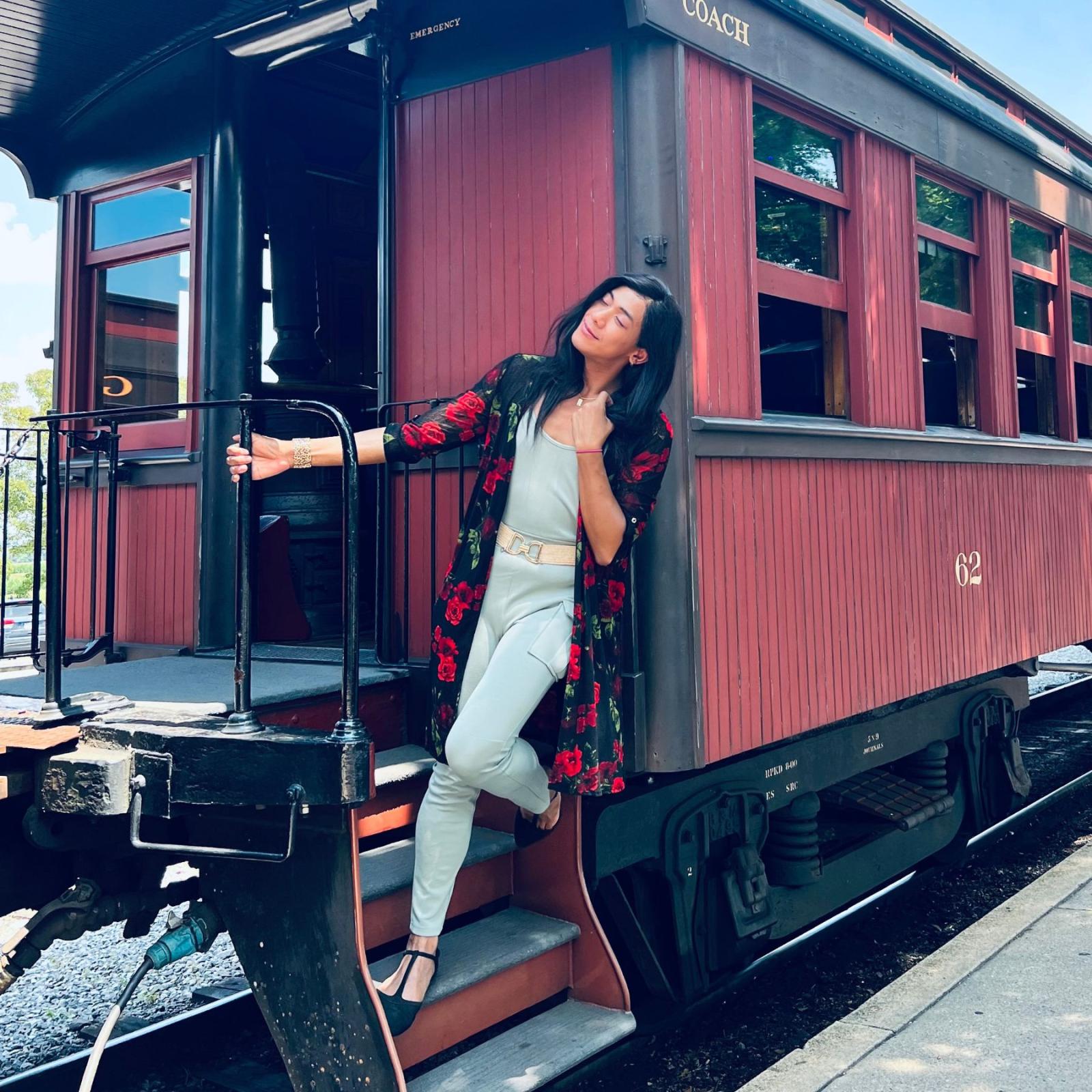 Pace University Seidenberg student, Mochii de Castro posing with a train car