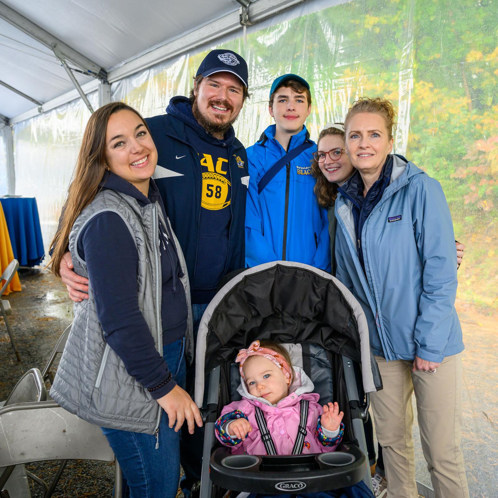 Group shot of family members with their Pace University students smiling at the camera at Homecoming.