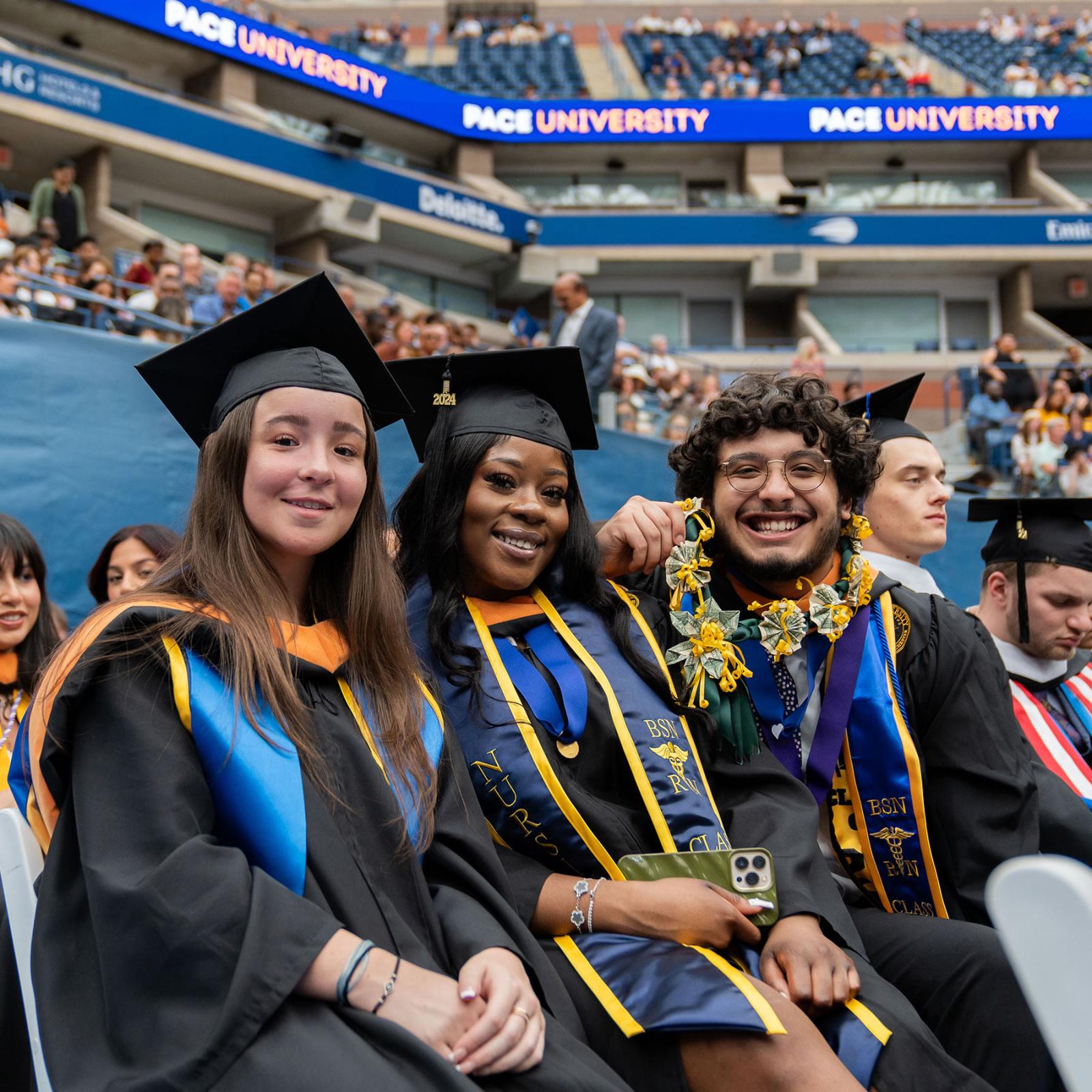 Pace University students posing for a photo at the 2024 commencement ceremony in NYC.