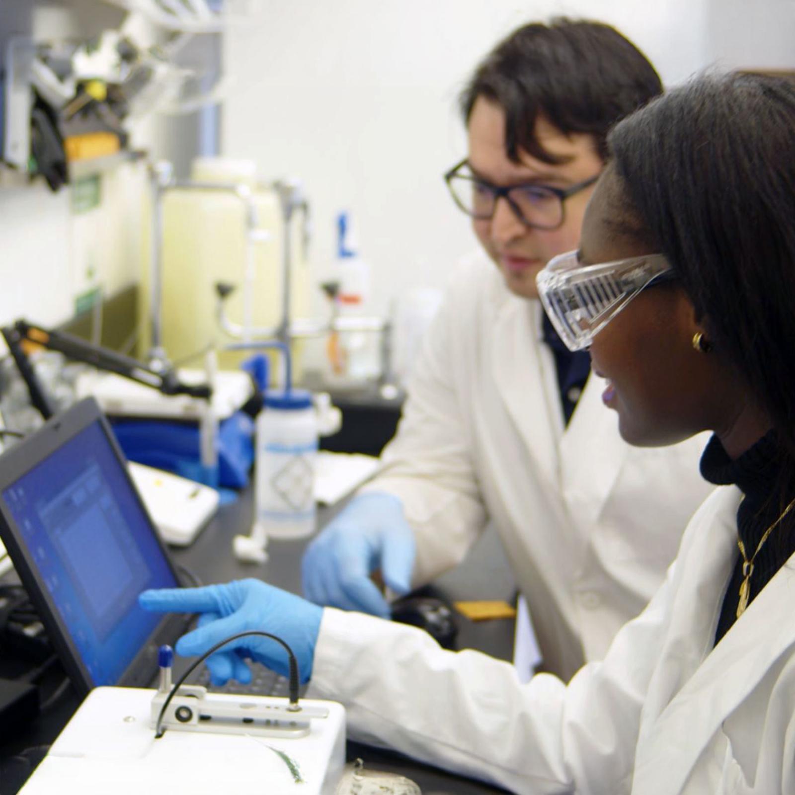 Pace University's Chemistry and Physical Sciences student Immala Rousier with Associate Professor Eric Chang, PhD, working in the lab with equipment on the New York City Campus