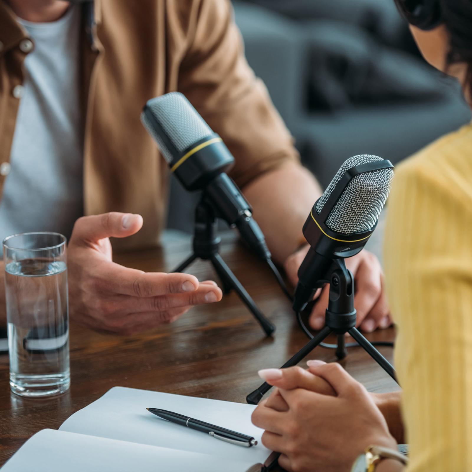 close up of people talking to each other using microphones. 