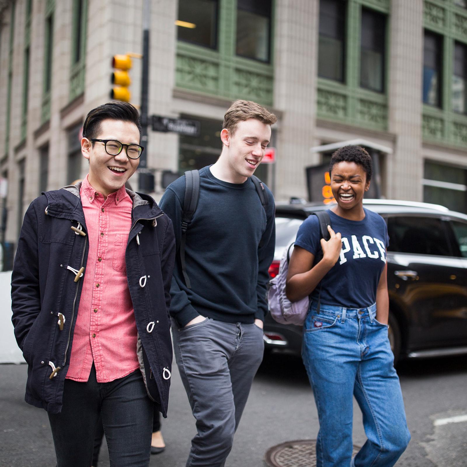 Three Pace University students walking the streets of Manhattan