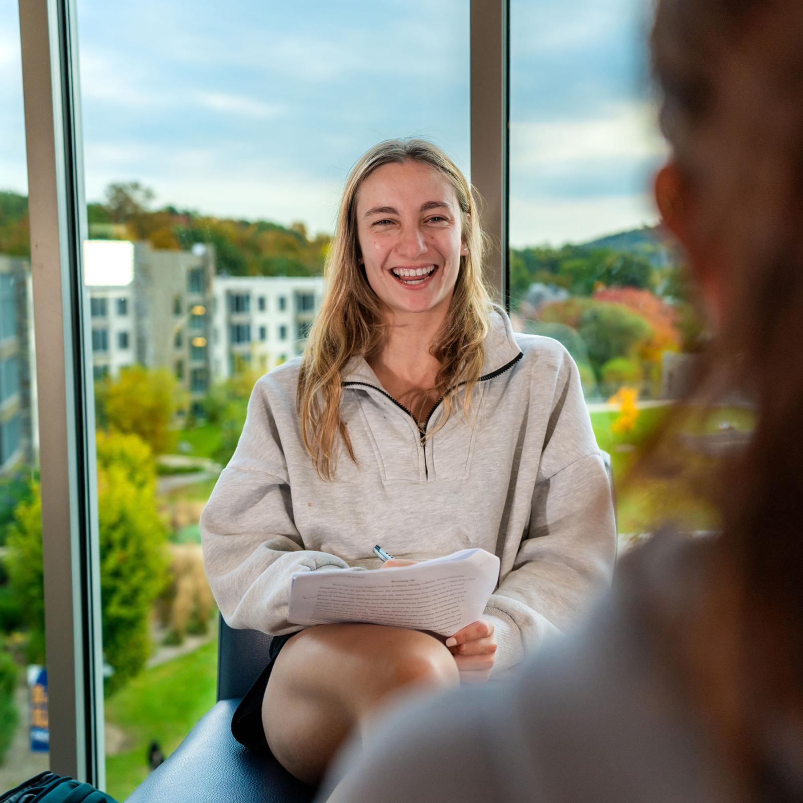 Pace University student smiling while studying in the Kessel Student Center