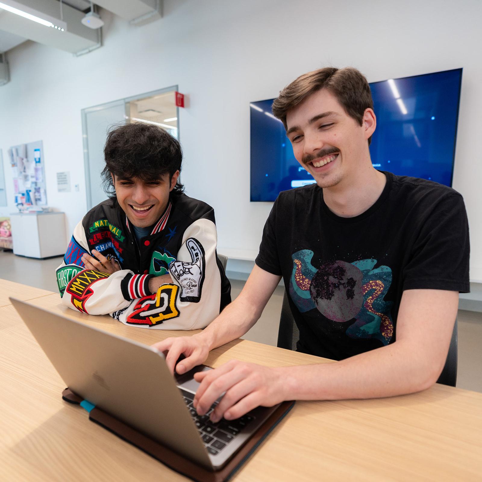 Pace University students learning at a computer