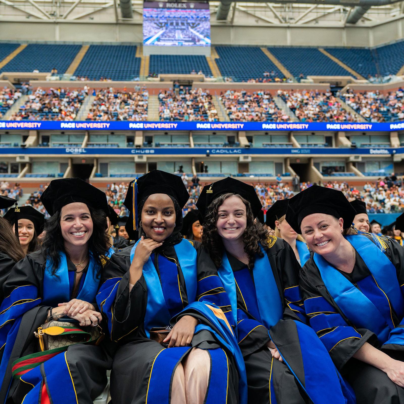 4 Pace University Graduates posing for a photo at the 2024 Commencement Ceremony.