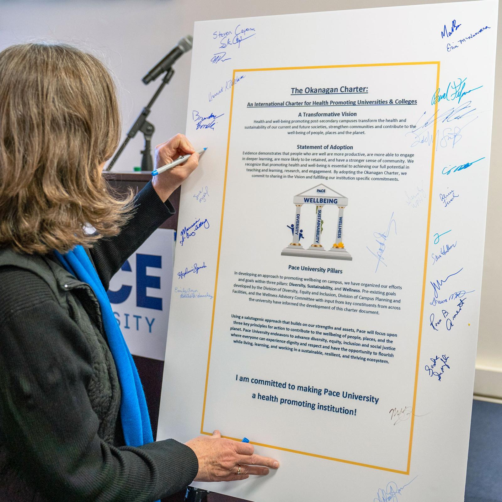 An individual signing the Pace University Okanaga Charter