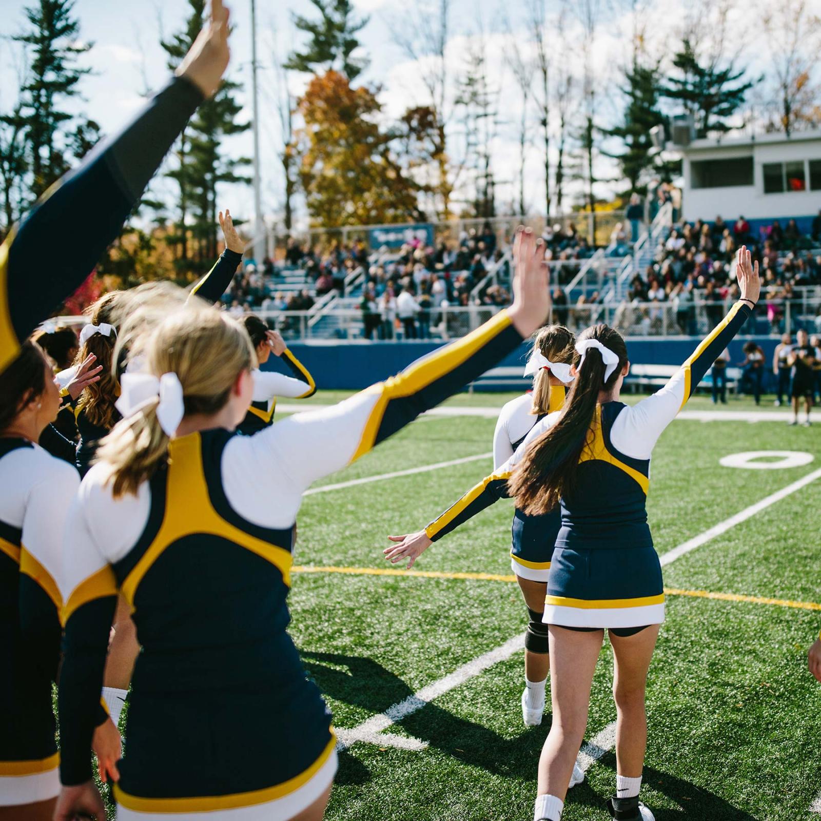 Pace University Cheerleaders performing to crowd at football game