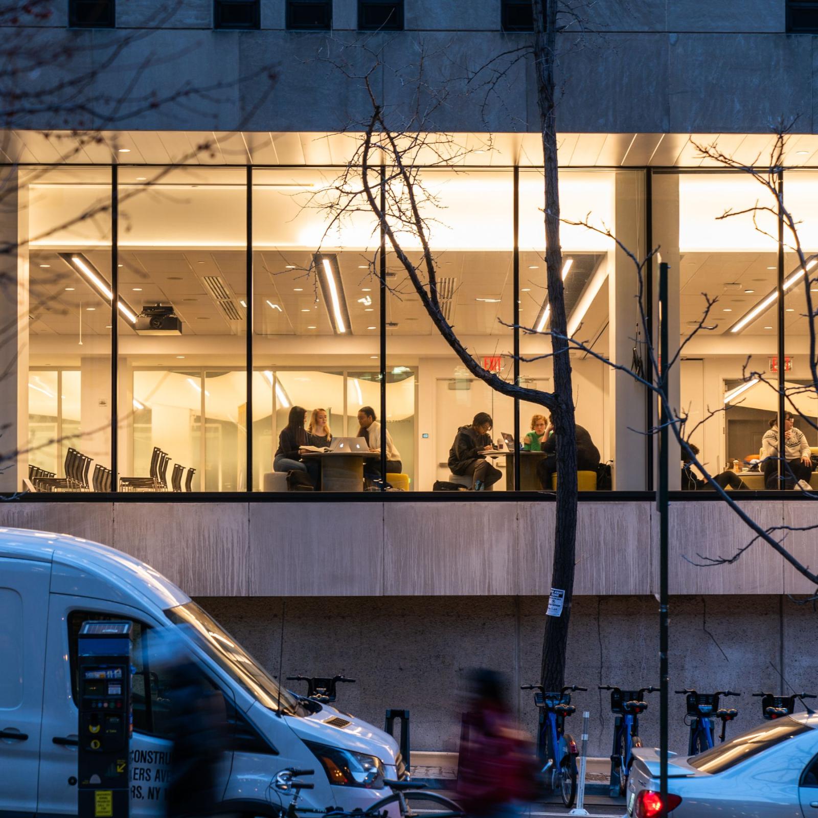 Pace University view of students studying at a table from the exterior