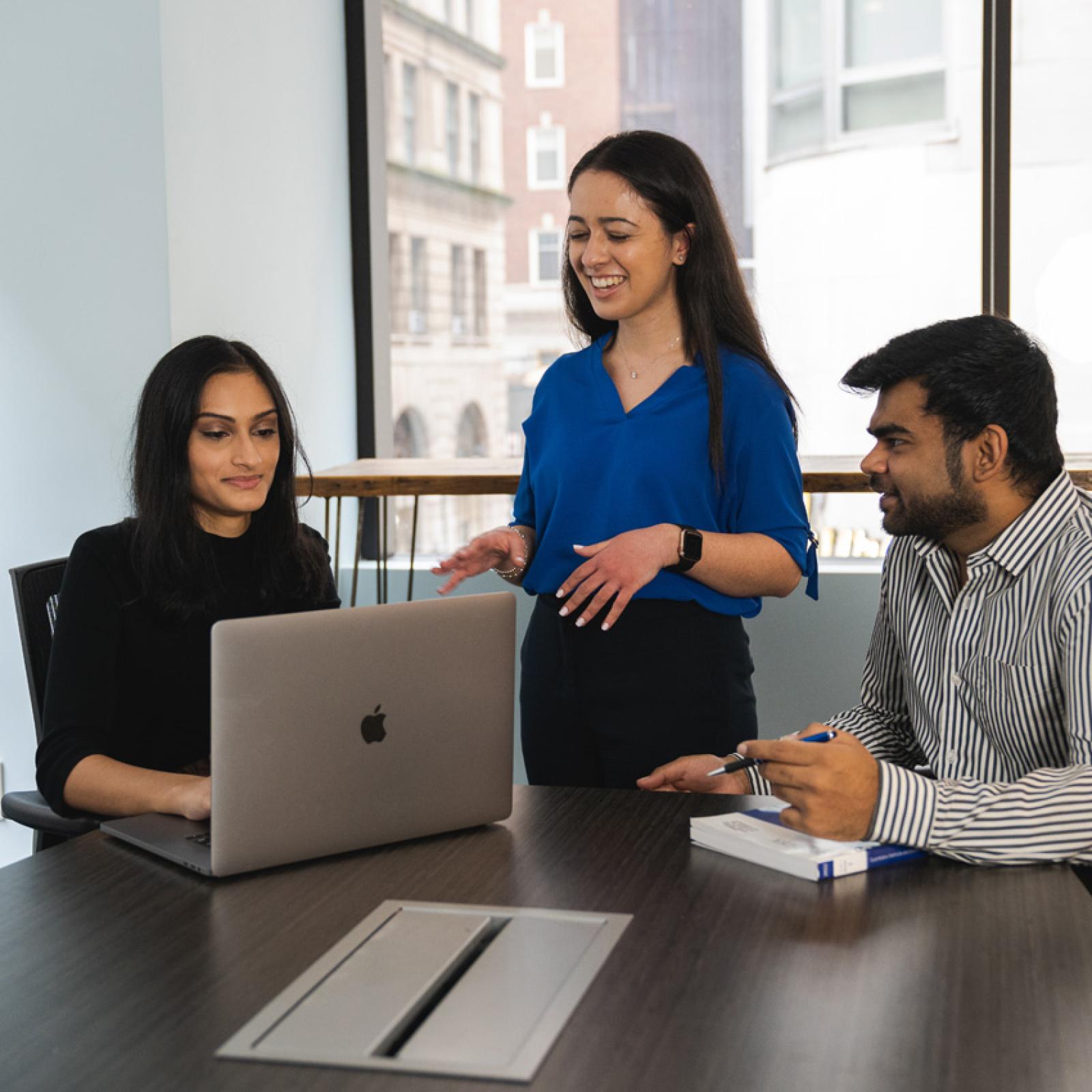 A group of young professionals working at a table. 