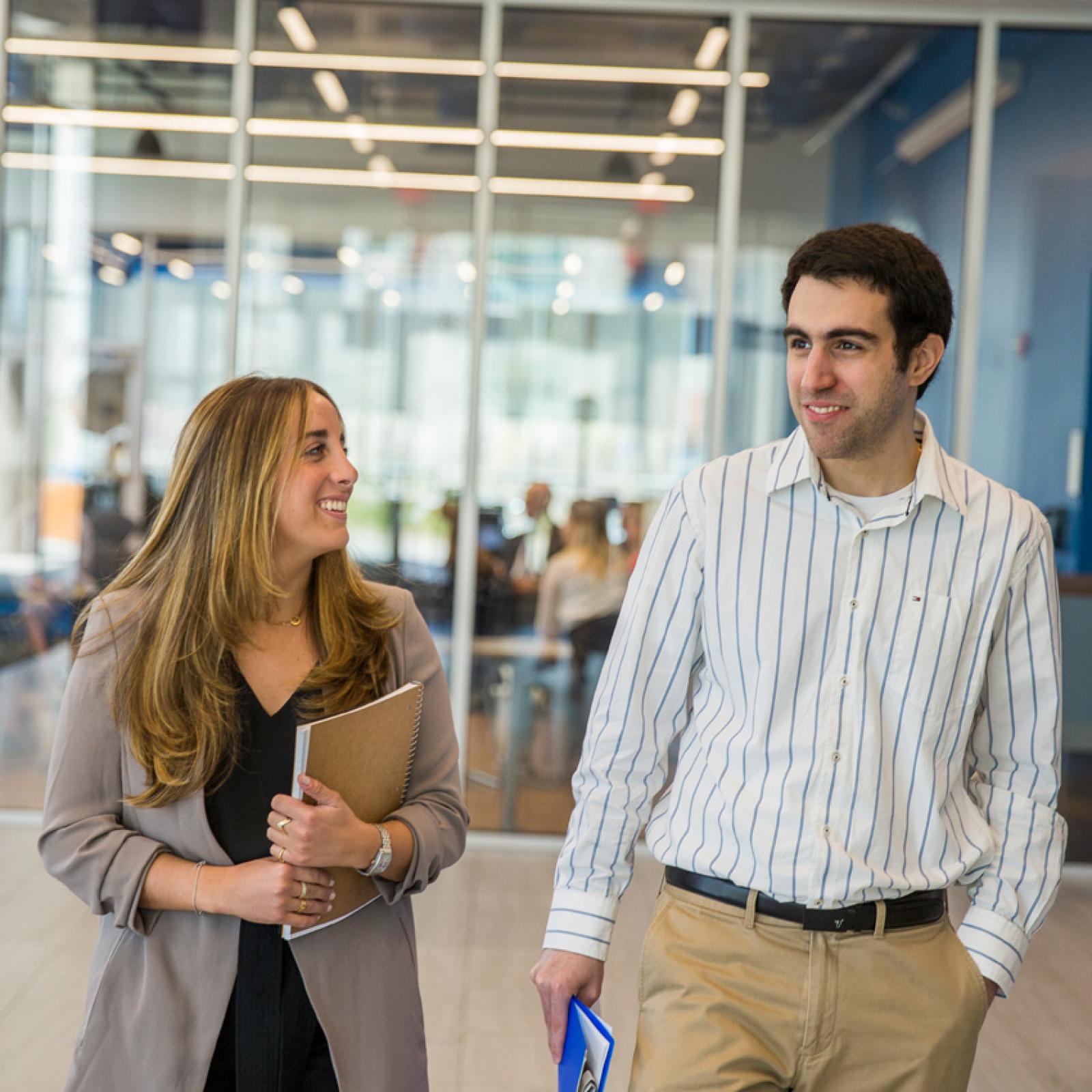 Students in business casual attire walking on the Pace University campus. 