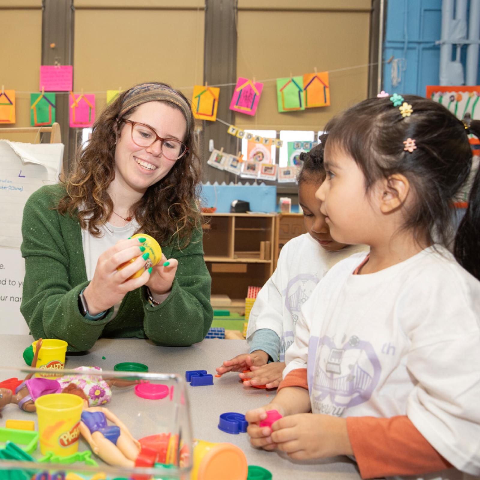 A Pace University student teacher working with students in an elementary classroom.