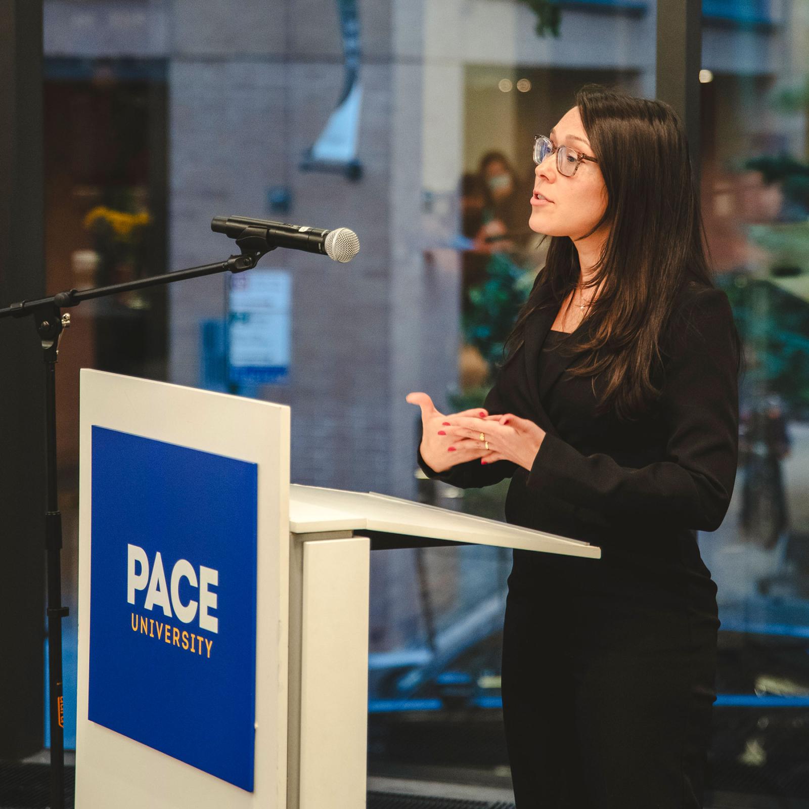 Pace University Public Administration student speaking behind a podium