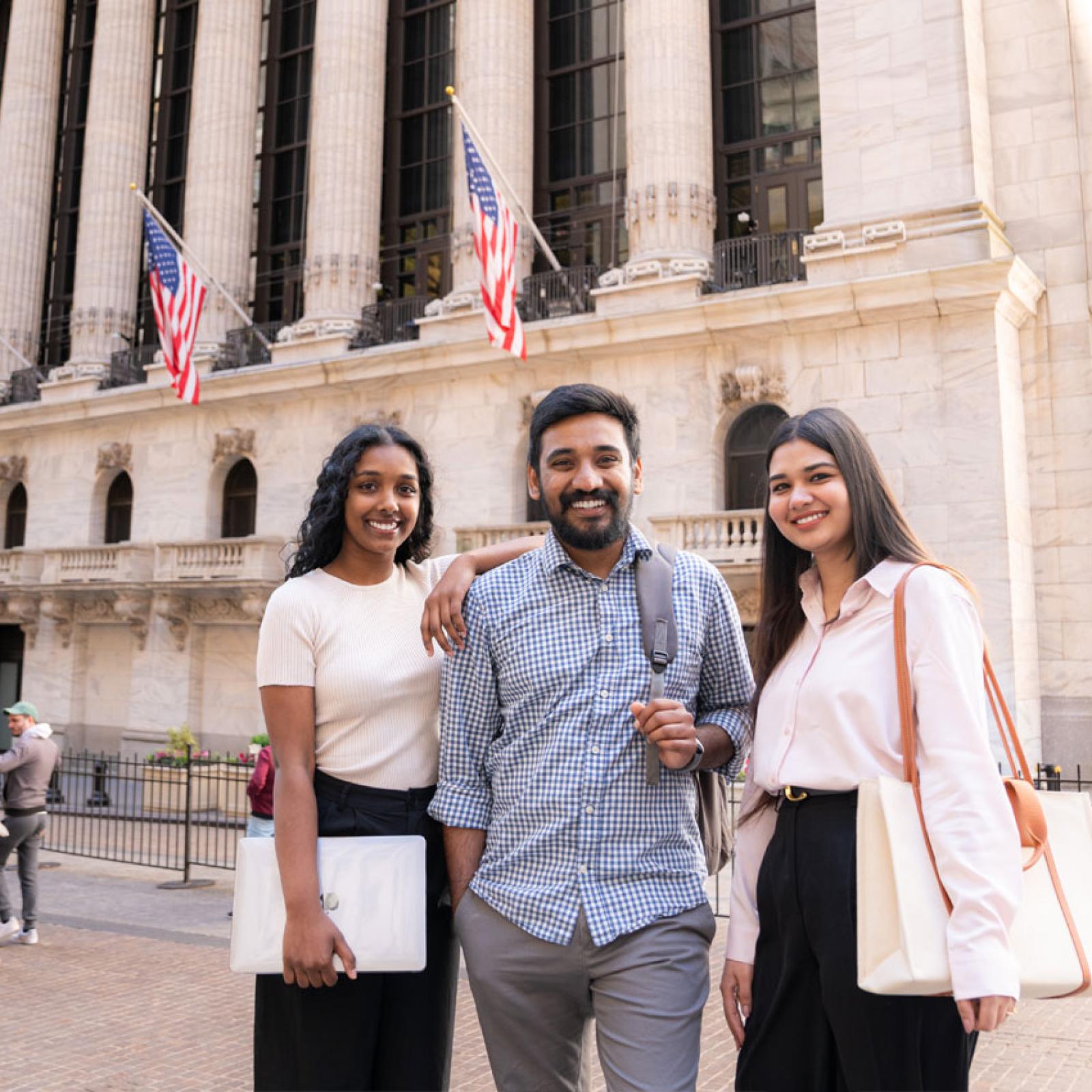 Pace University students standing on Wall Street.