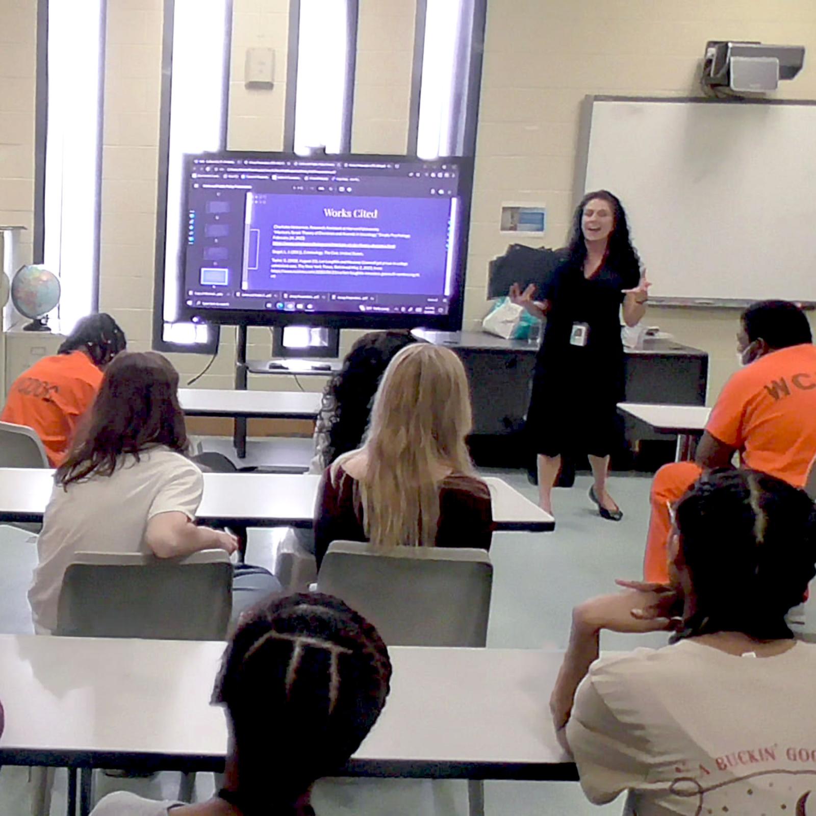 Pace University Criminal Justice and Security students with incarcerated men in a classroom with a presentation at front