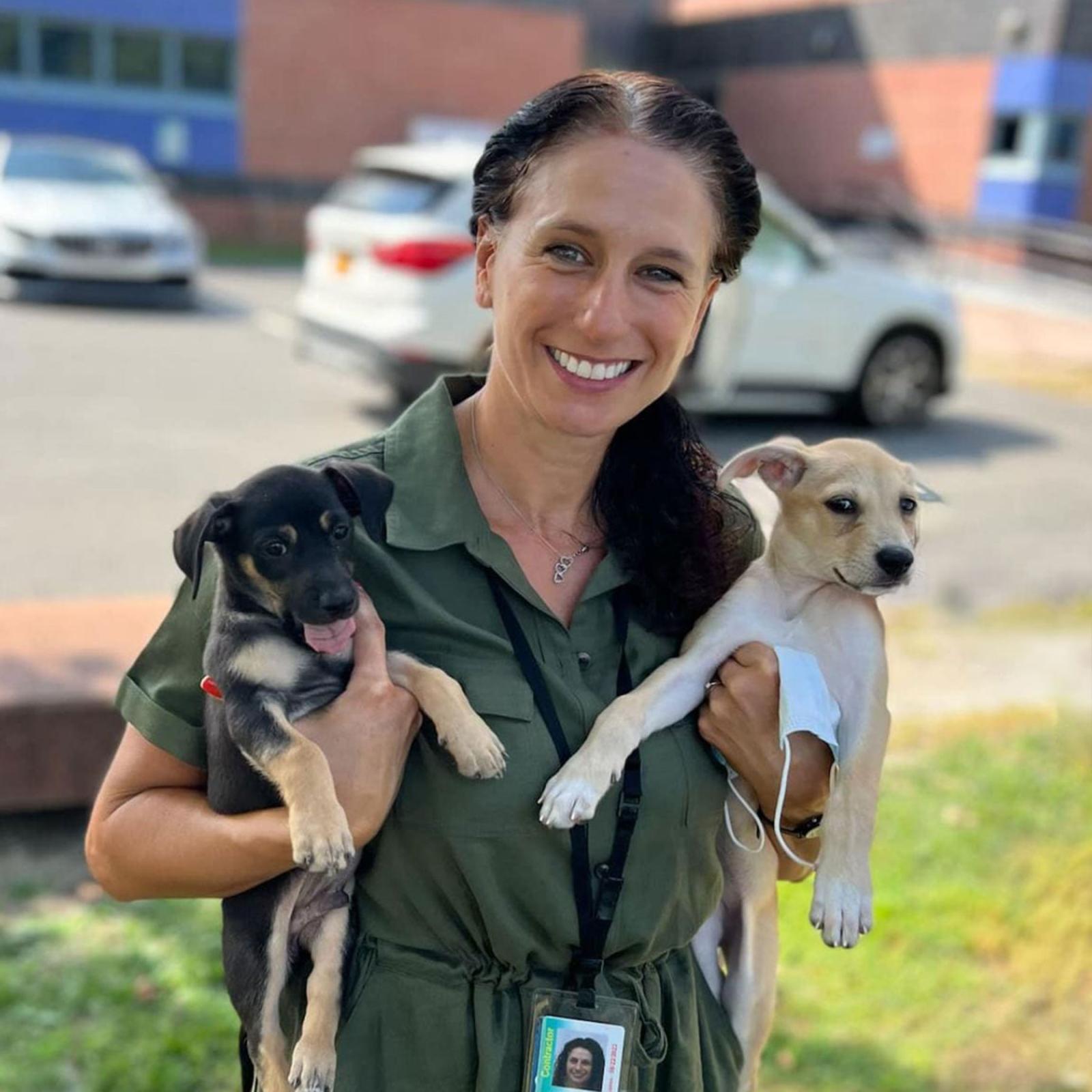 Pace University Director of Jail-Based Programs and Criminal Justice and Security professor Kimberly Collica-Cox holding two puppies