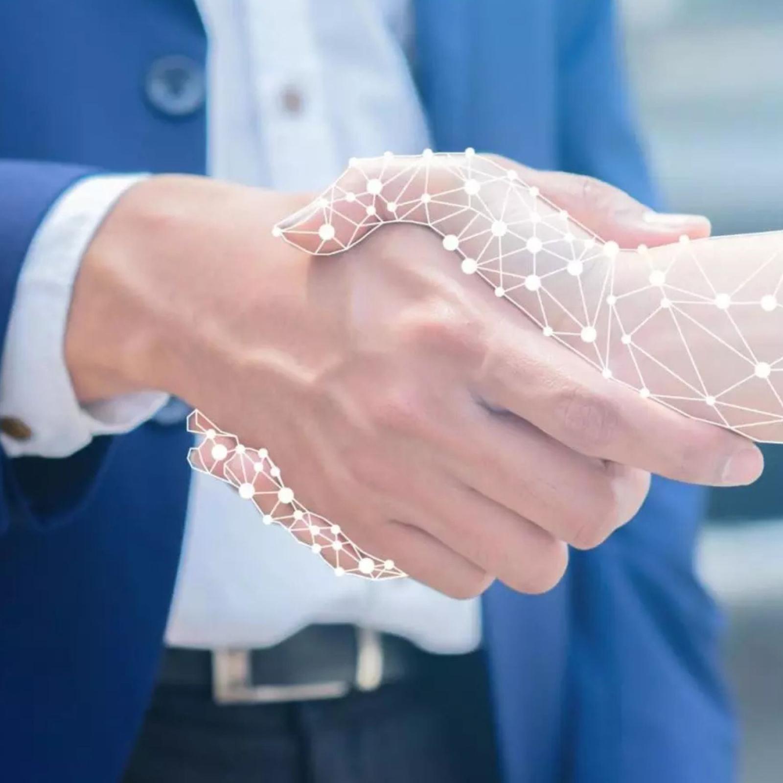 A man in a suit shaking hands with a cybernetic arm.