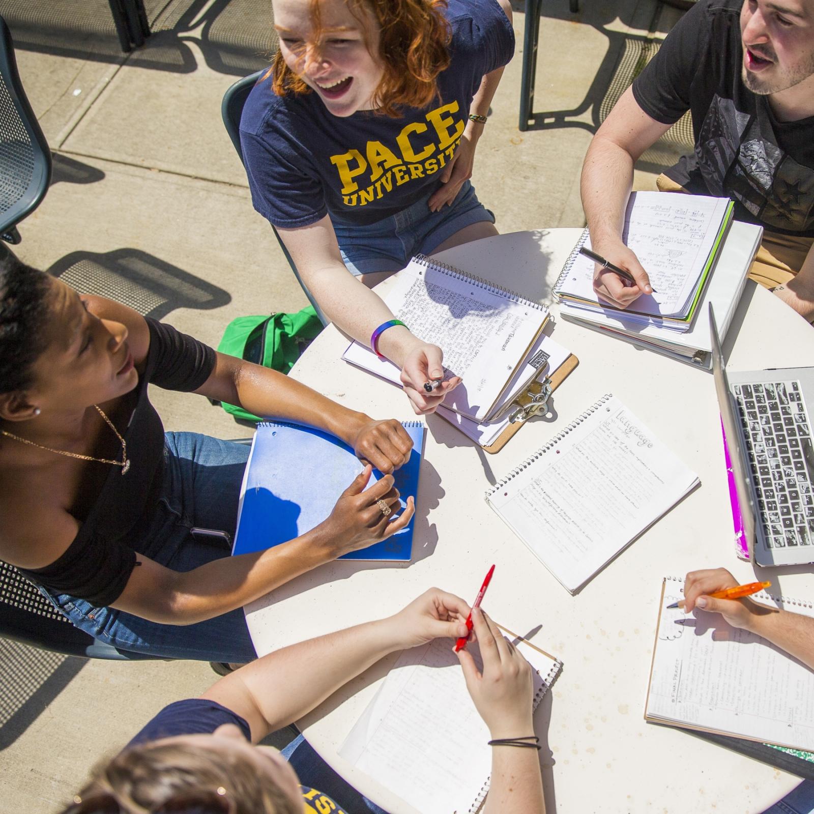 Pace students studying and working together around a circular table